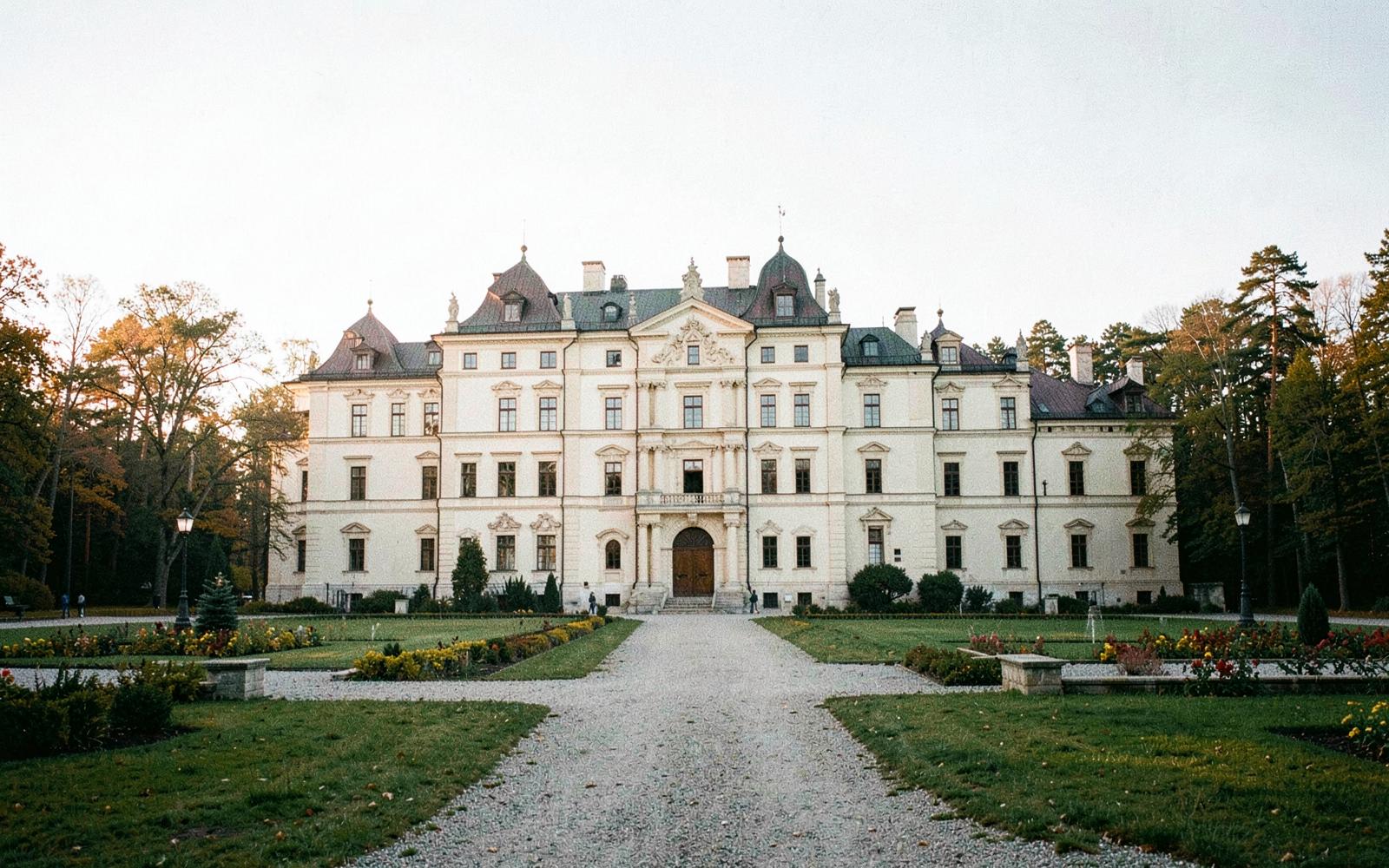 Editorial photograph of a historic European estate in summer light