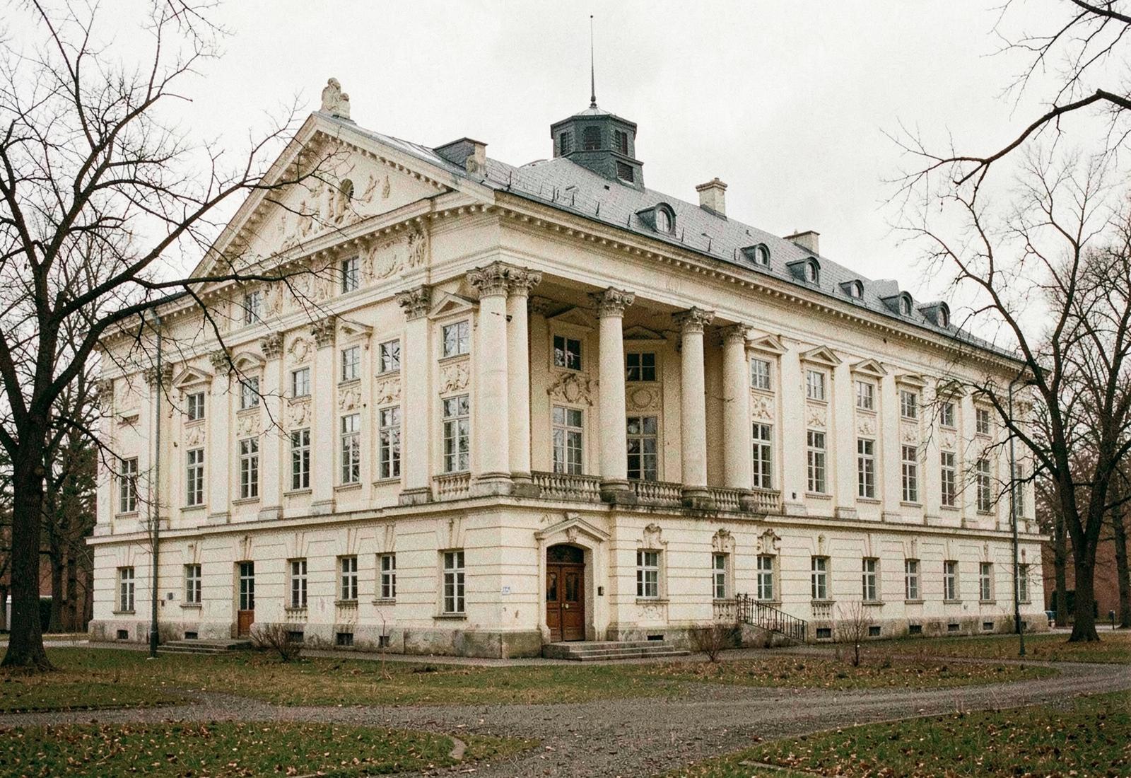 Editorial photograph of a classical estate and parkland in soft light
